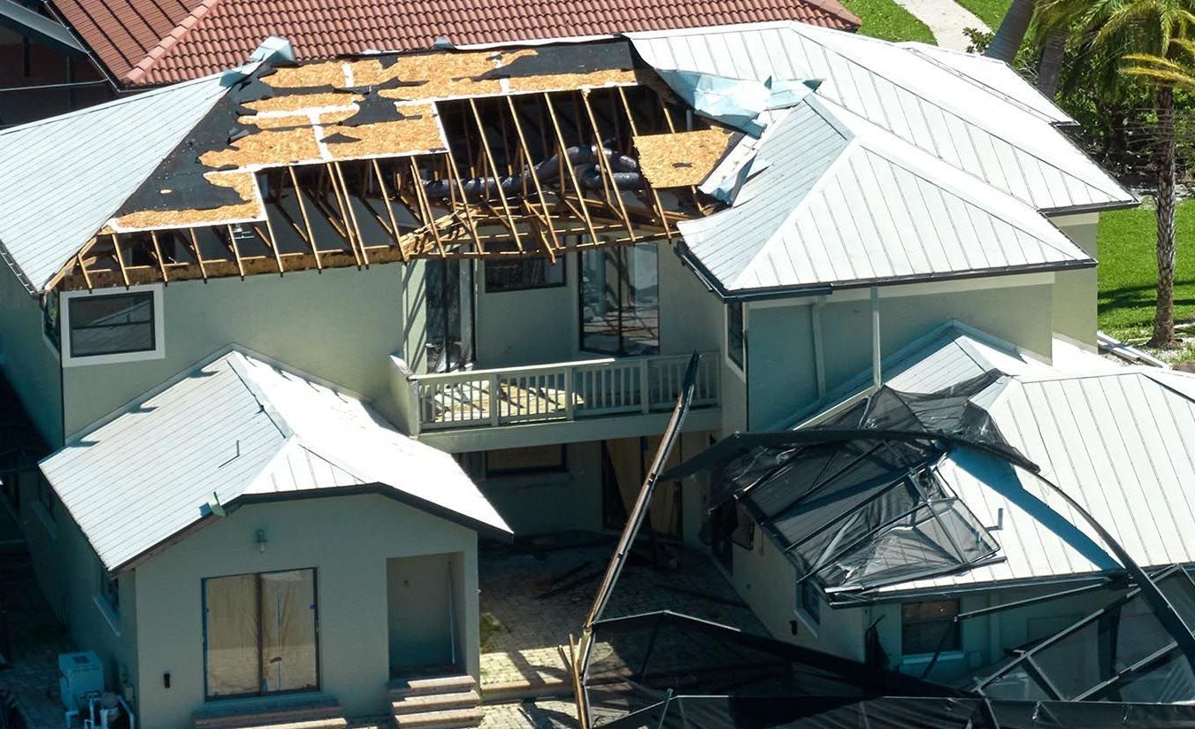 An aerial view of a house that has been damaged by a hurricane