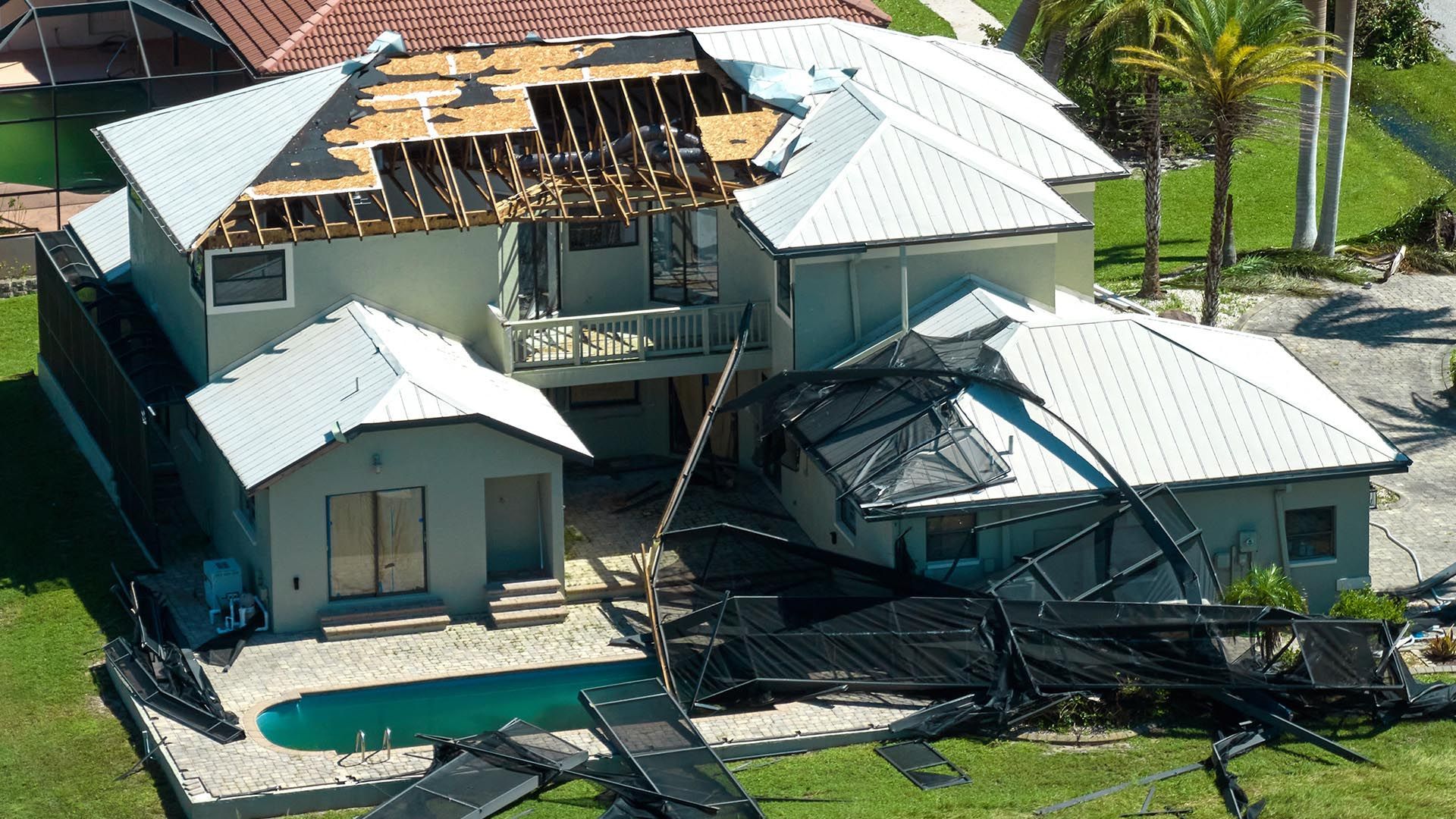 An aerial view of a house that has been damaged by a hurricane