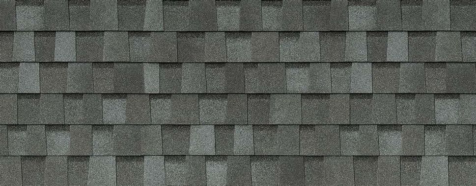 A close up of a roof with gray shingles.
