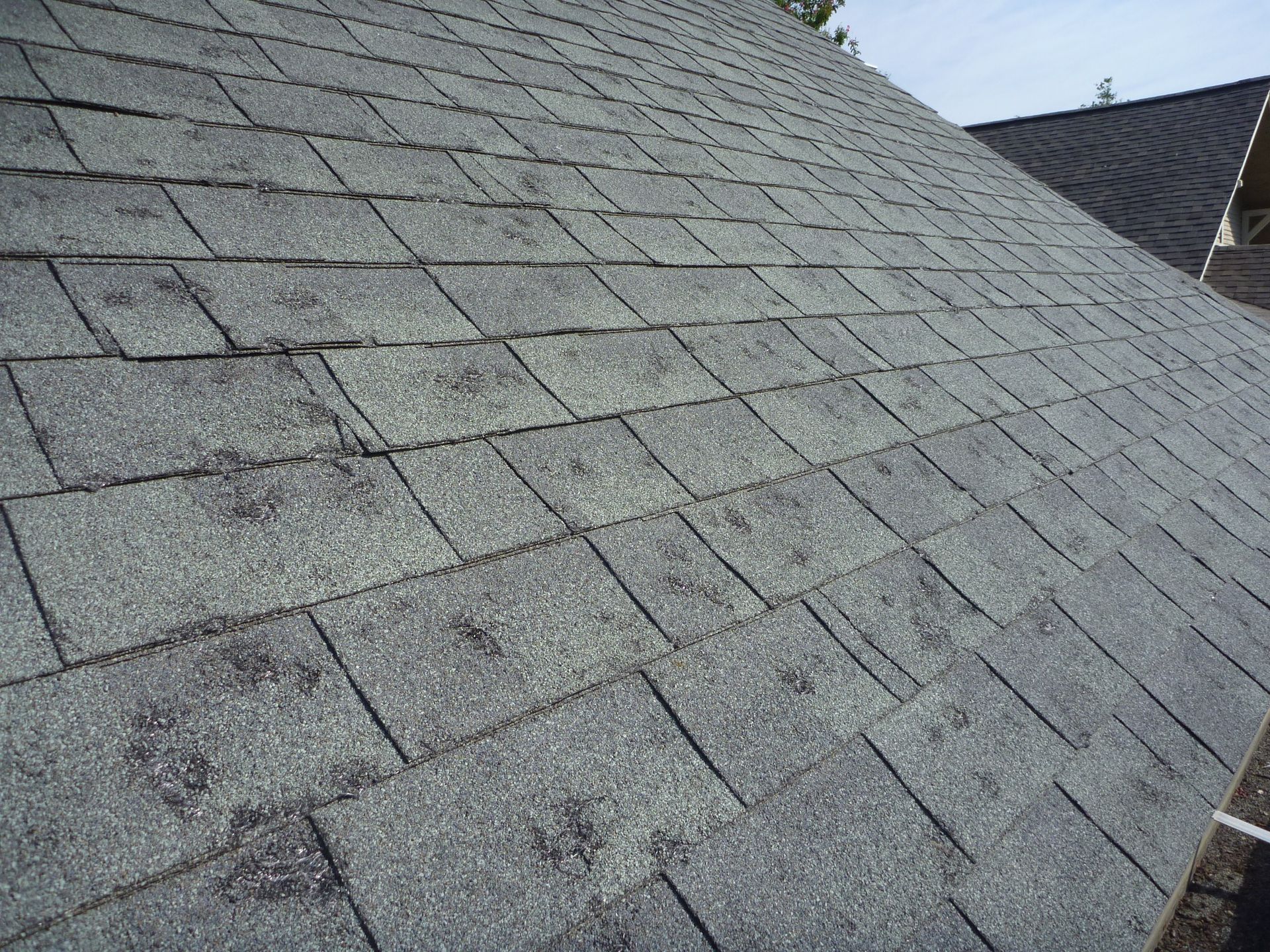 A close up of a roof with a lot of shingles on it.