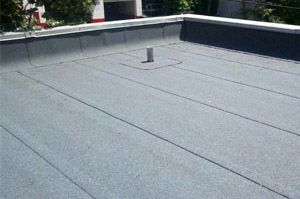 A roof with a gray roofing material on it.