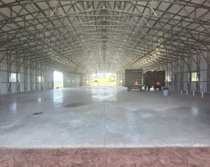An empty warehouse with a truck parked inside of it