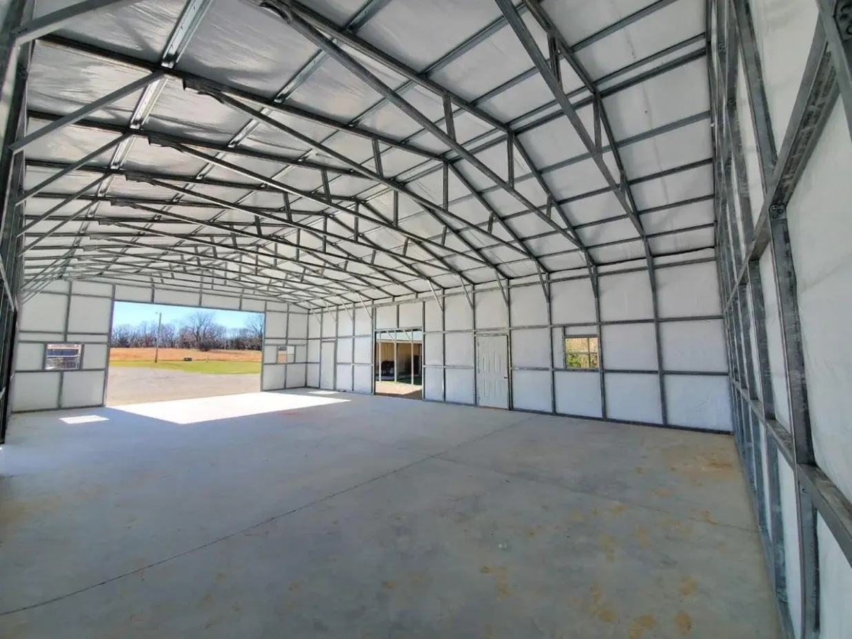A large empty building with a lot of windows and doors.