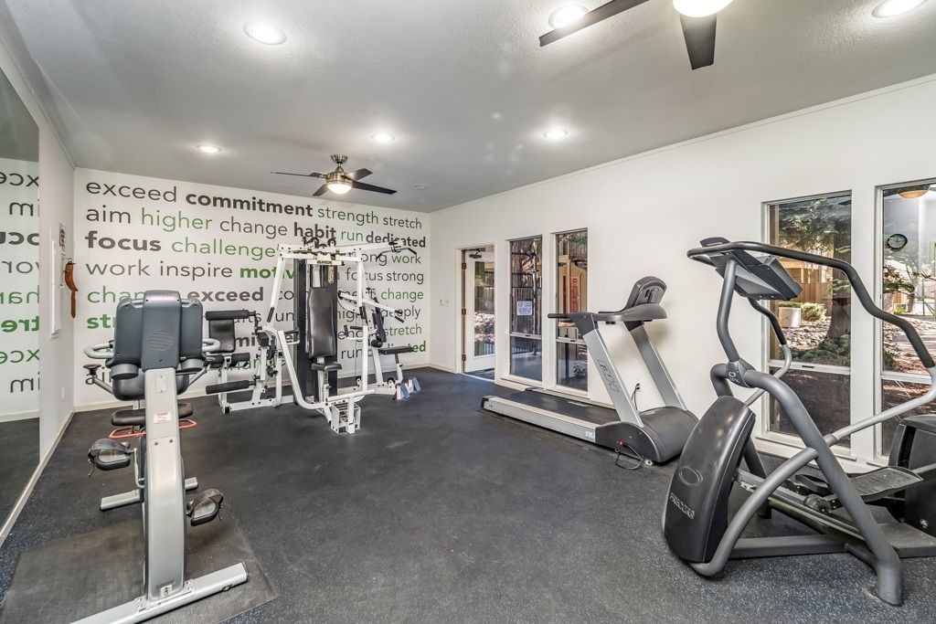Interior of a residential gym with treadmills and weight machines.