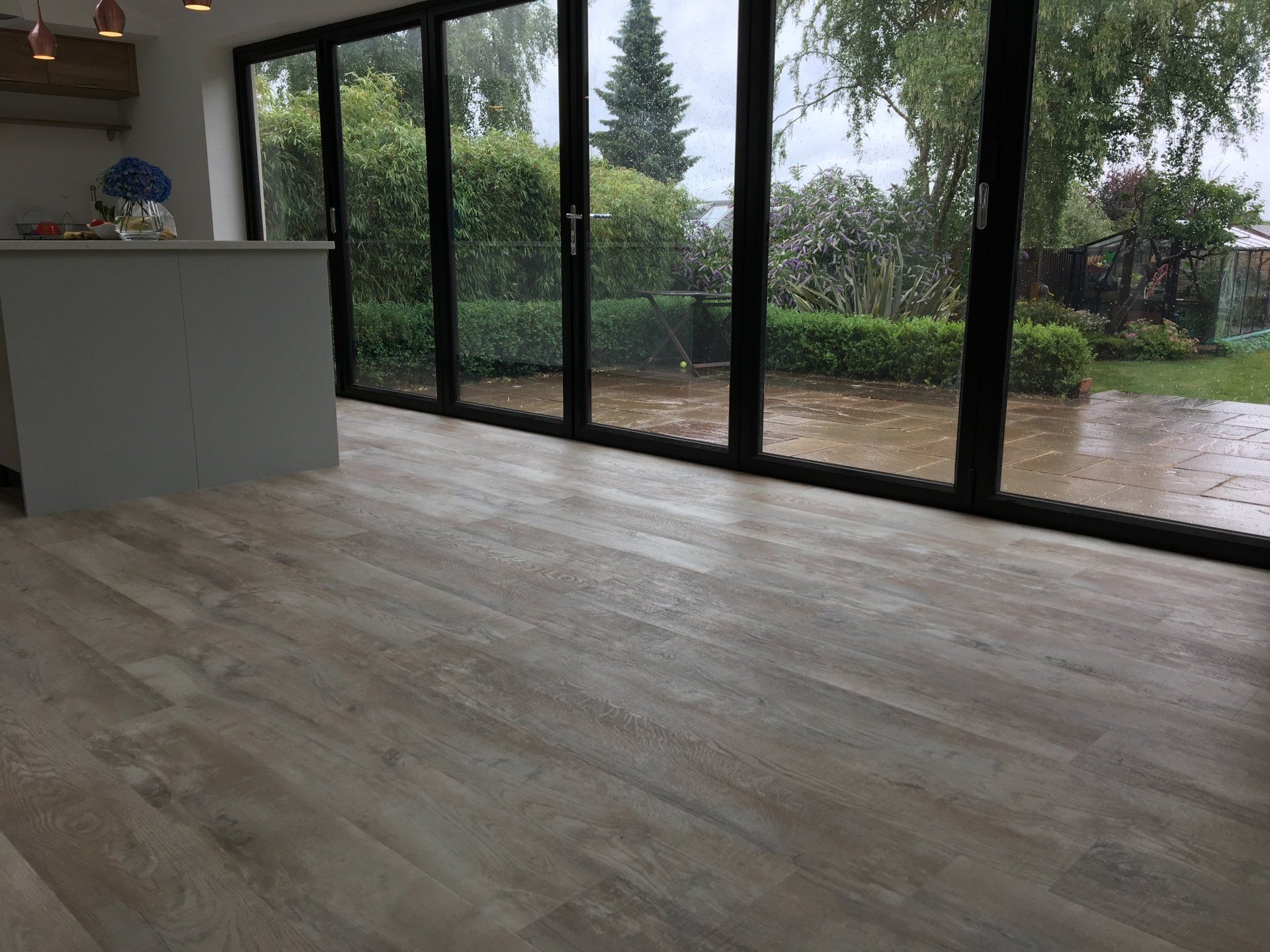 wooden flooring leading to patio doors