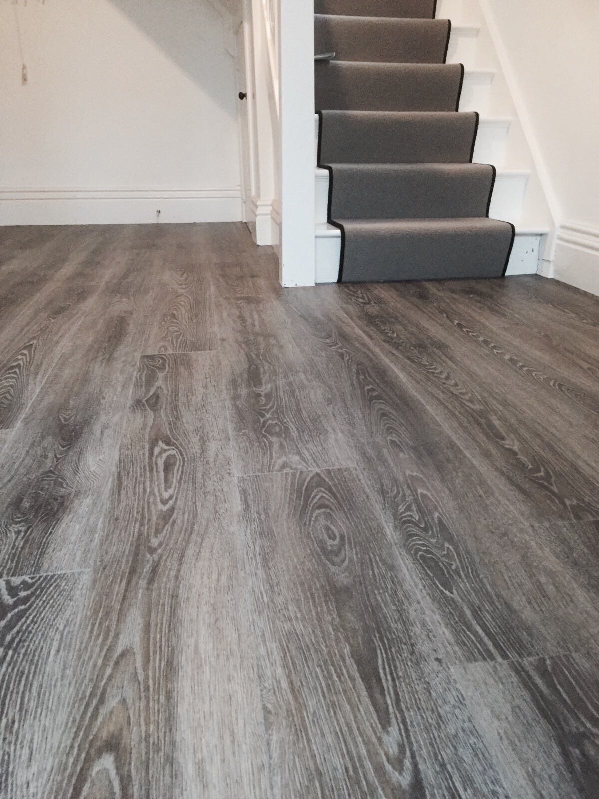 wooden flooring leading to carpeted stairs
