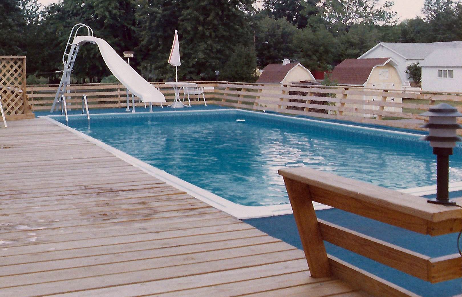 A large swimming pool with a slide attached to it