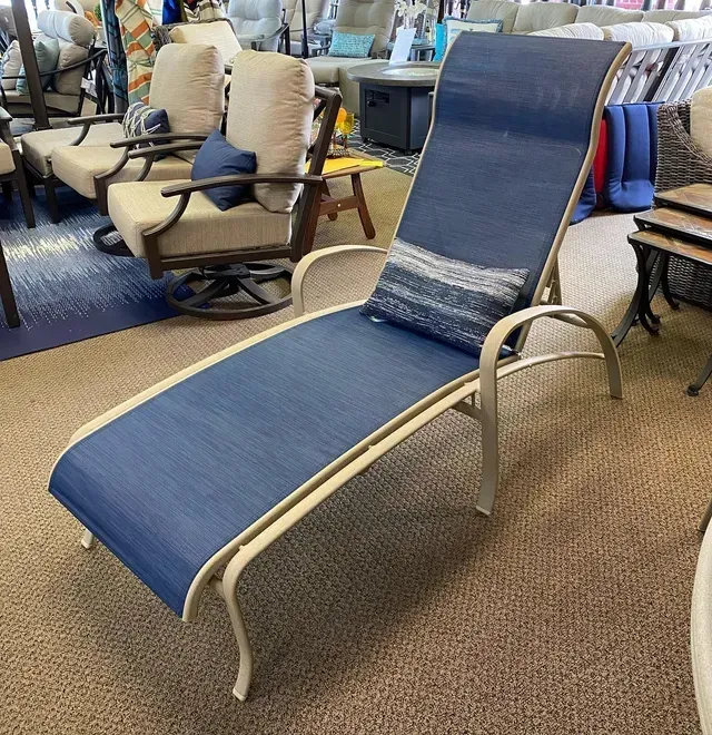A Blue Lounge Chair Is Sitting in A Room with Other Chairs.