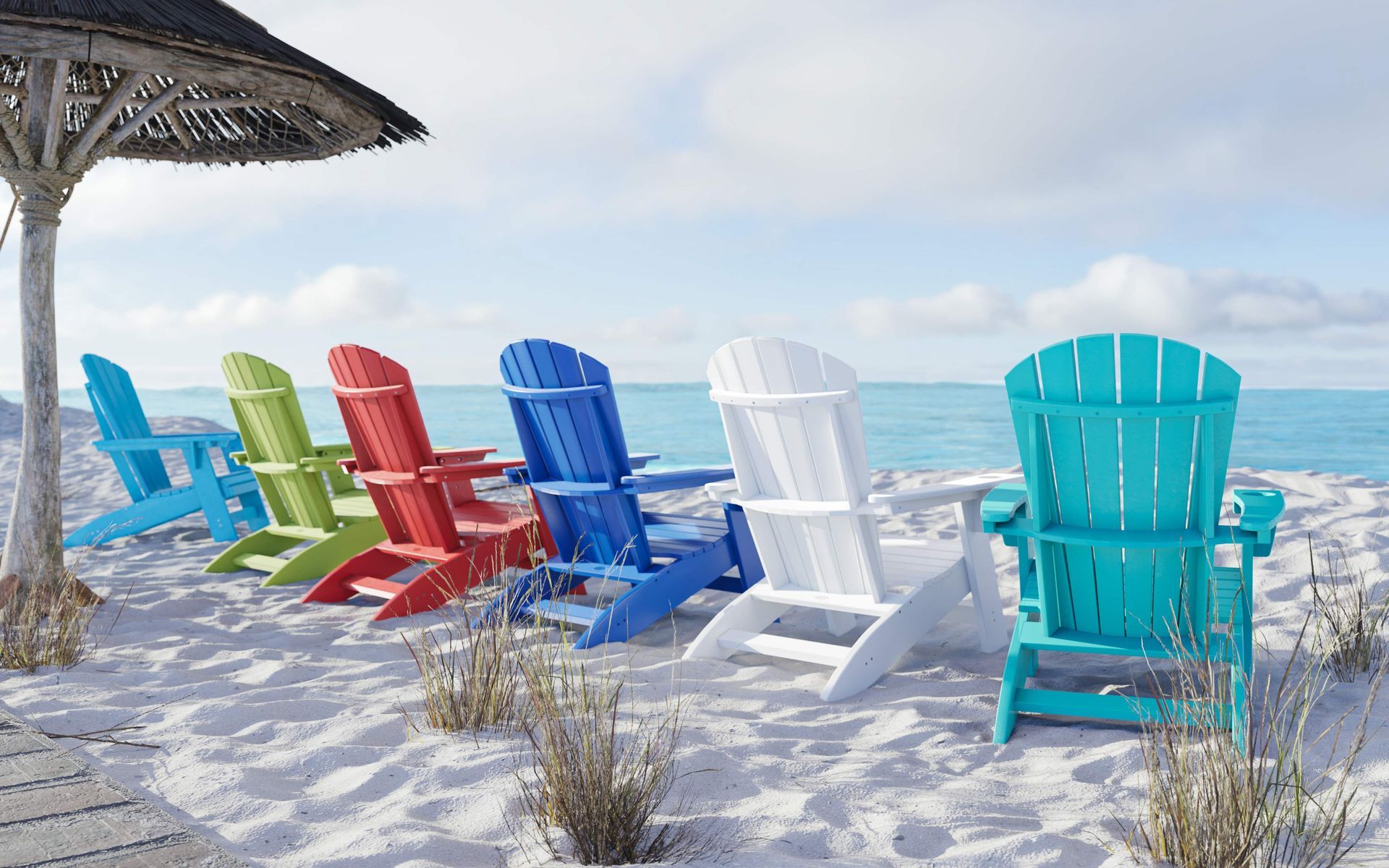 Colorful Adirondack chairs on a sandy beach overlooking the ocean under a thatched umbrella.