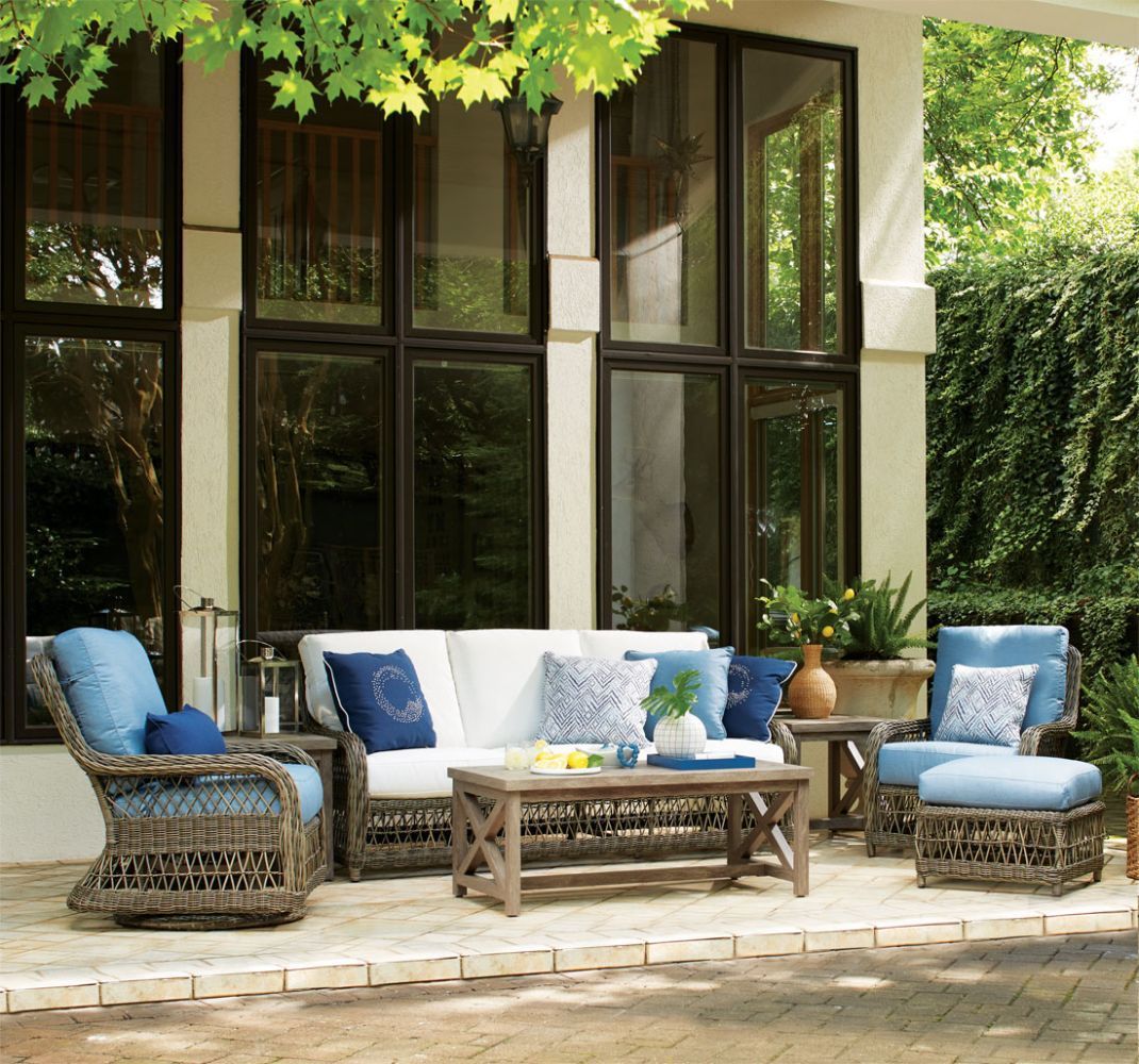 A patio with a couch , chairs , coffee table and ottoman