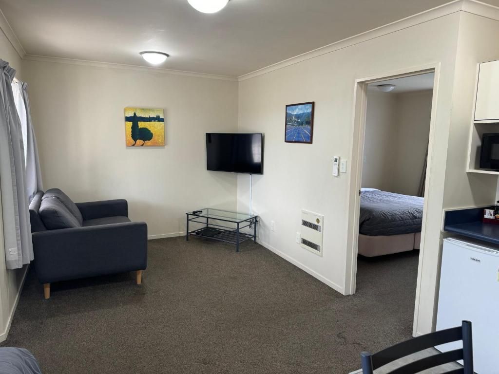 A living room with a couch and a flat screen tv.