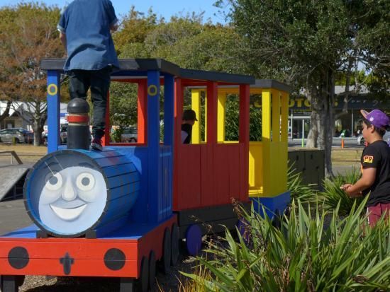 A colorful train with a smiling face on it