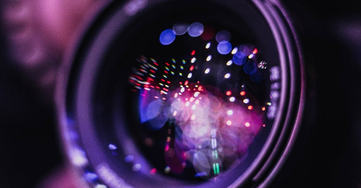 A close up of a camera lens with fireworks reflected in it.