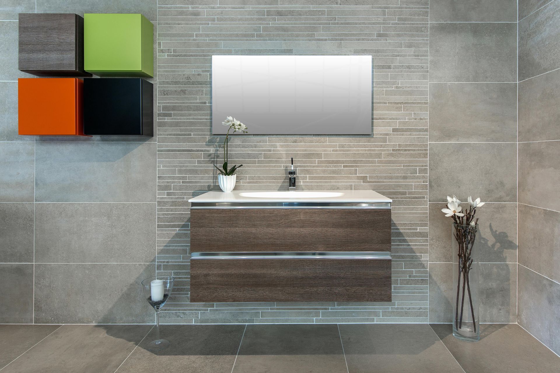 Modern bathroom with a floating vanity, mirror, and colorful wall-mounted cubes.