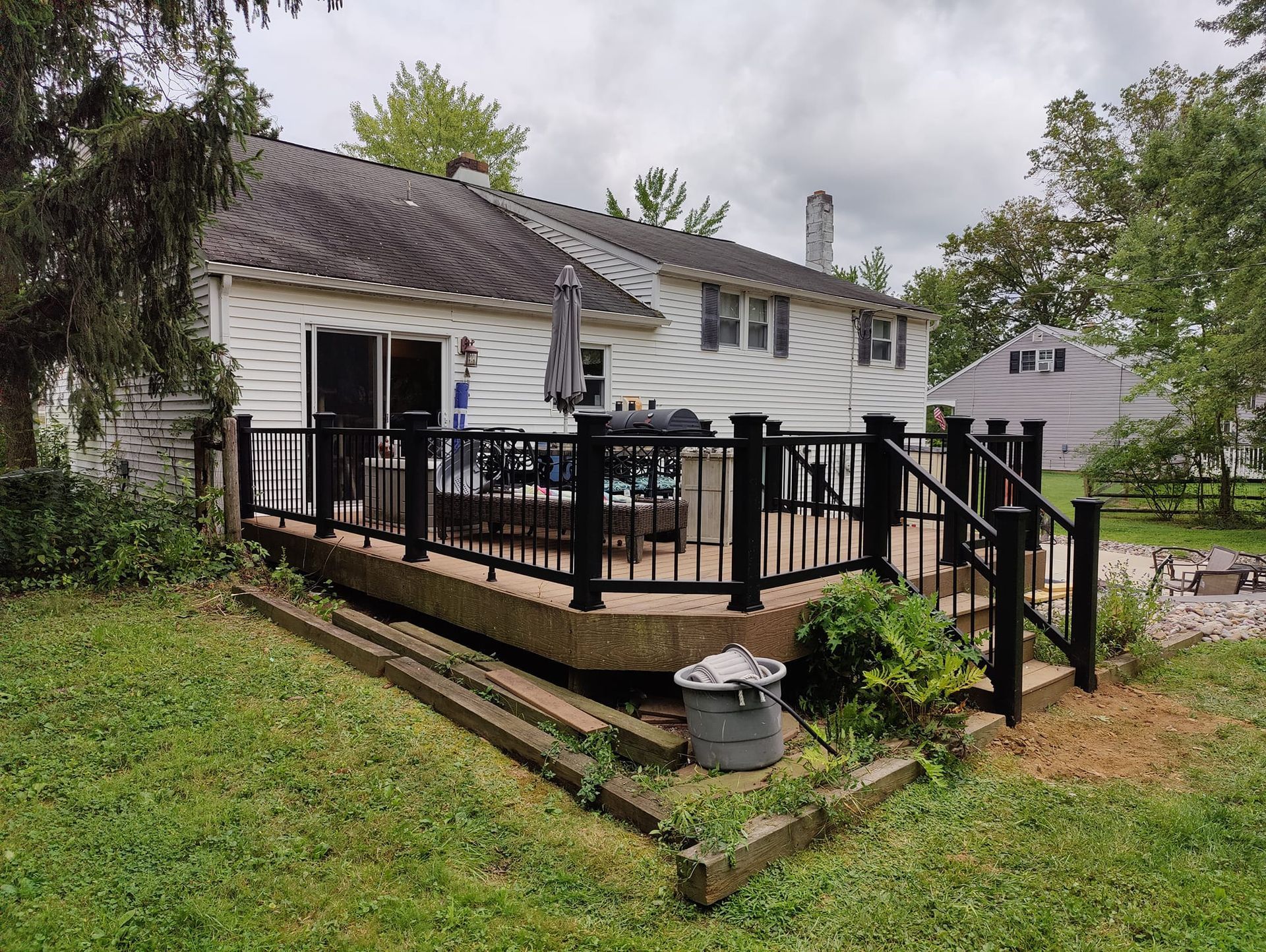 A house with a large deck and stairs in front of it.