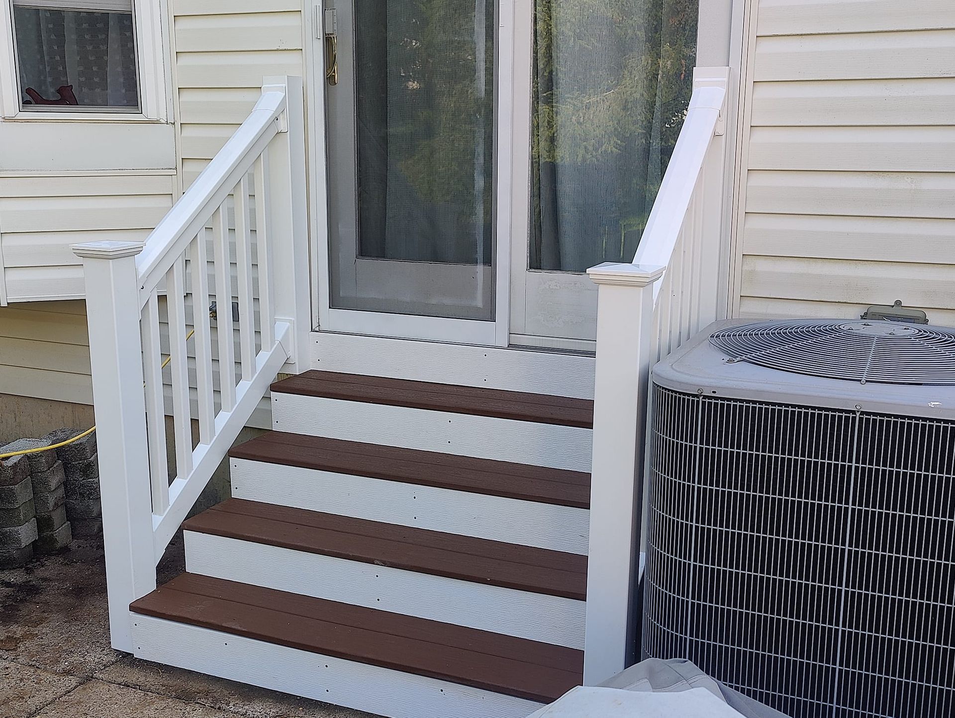 A white house with stairs leading up to the front door