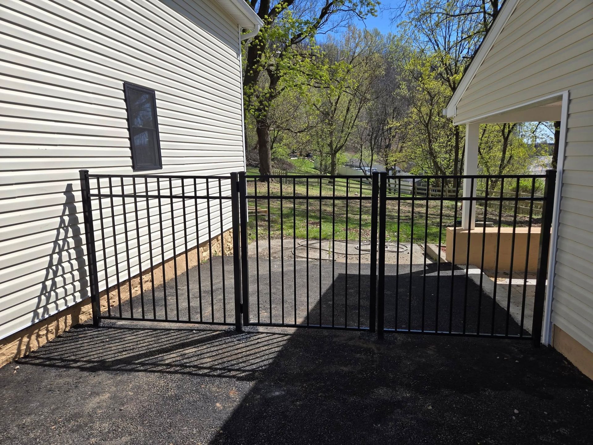 A white house with a black fence in front of it