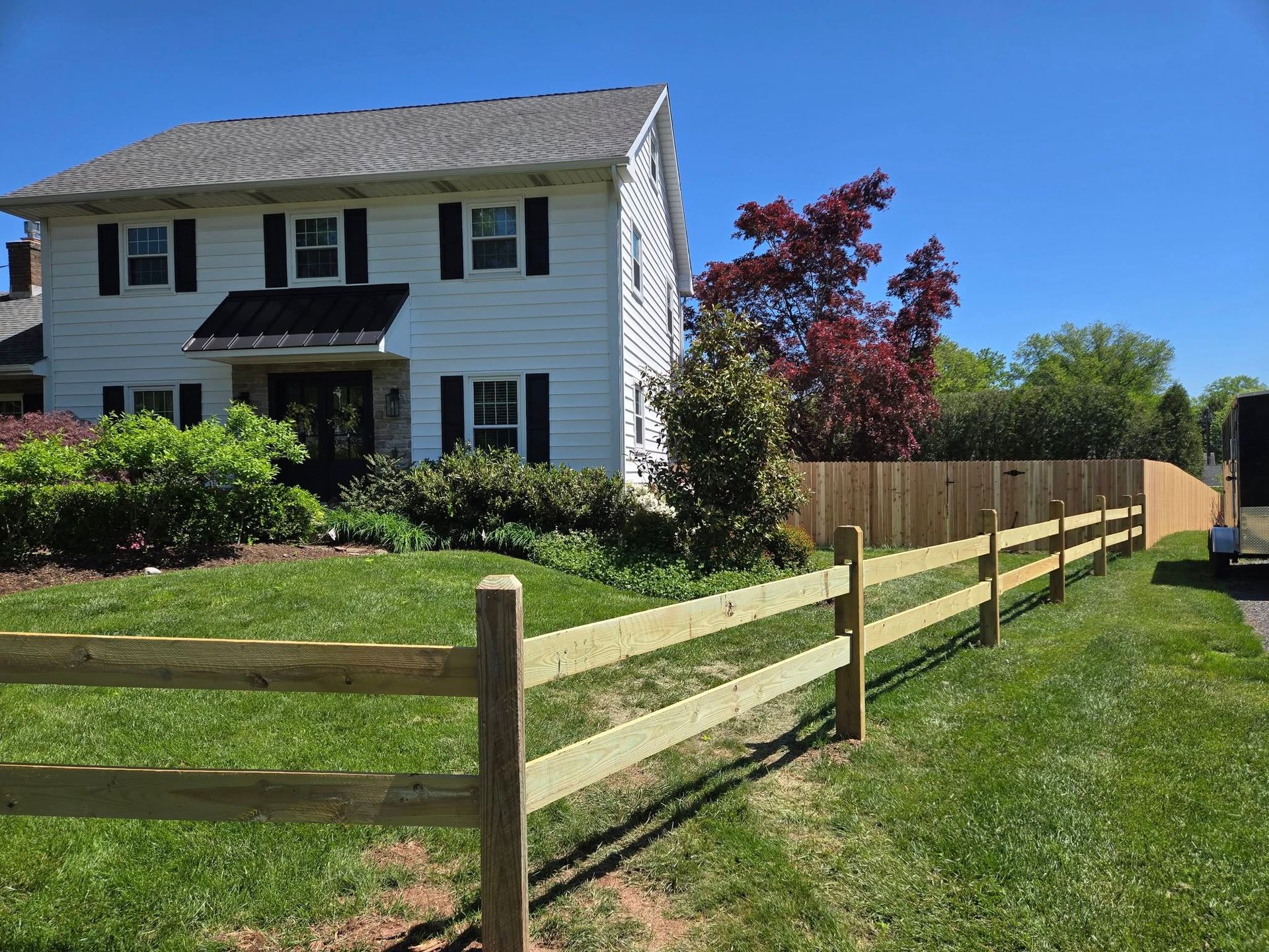 A house with a wooden fence in front of it