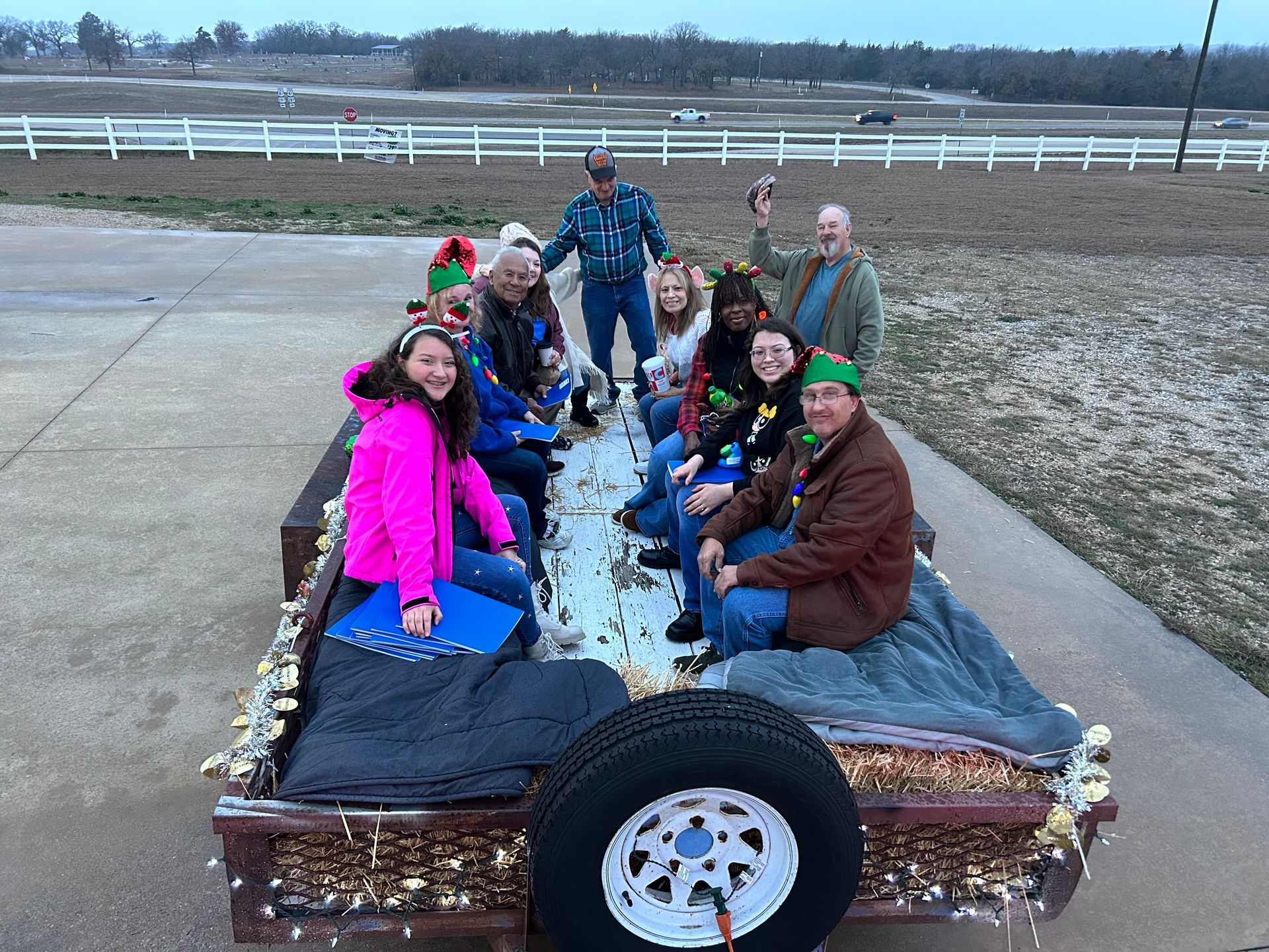 a man in a purple shirt is standing on a stage holding a microphone .
