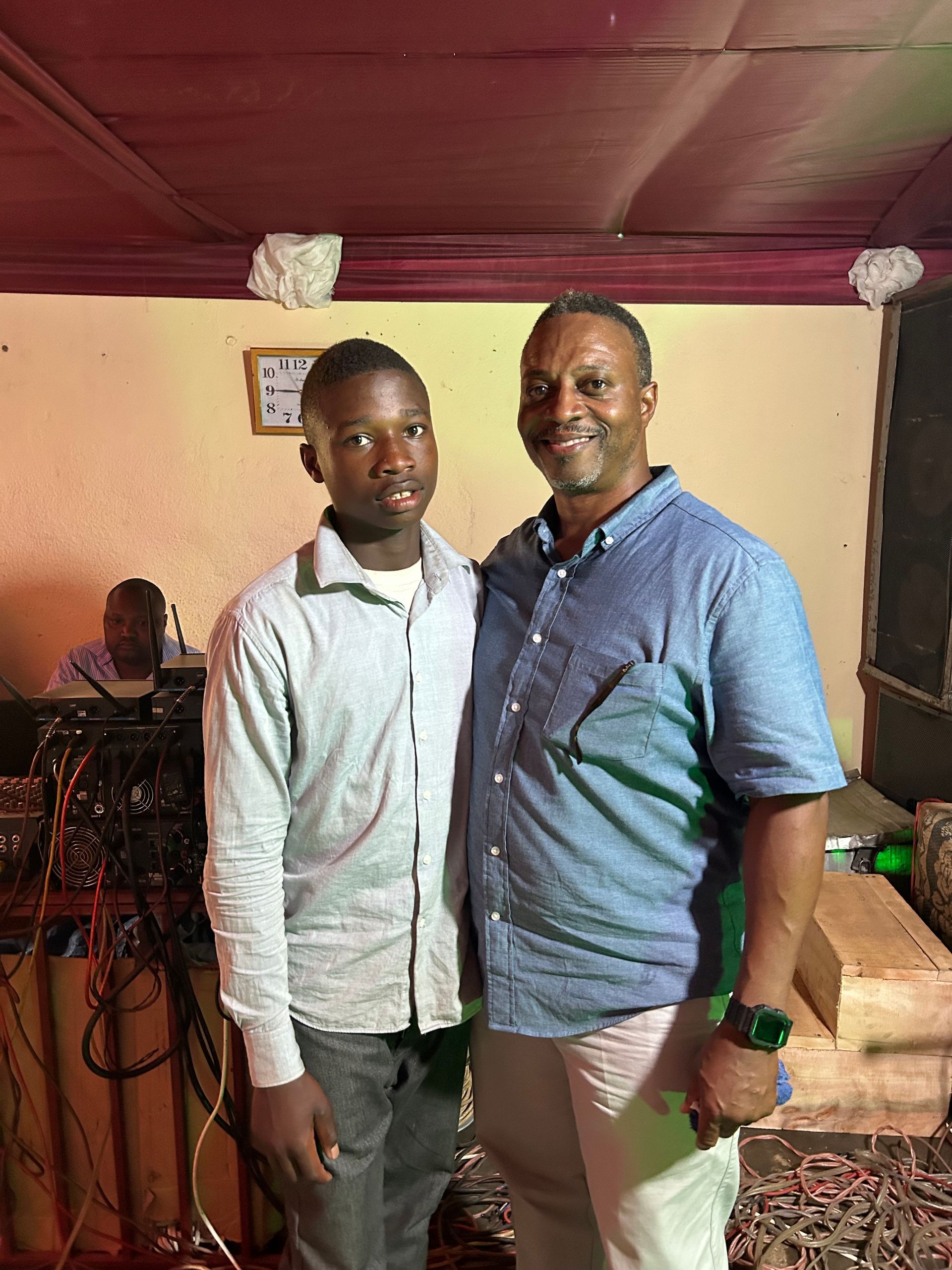 two men are posing for a picture in a room .