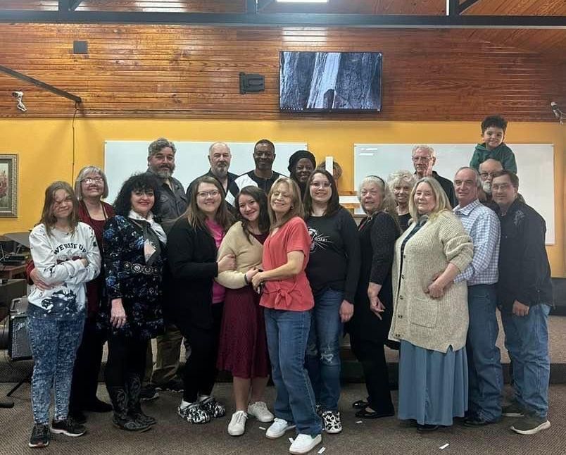 a person is holding a bible in their hand .