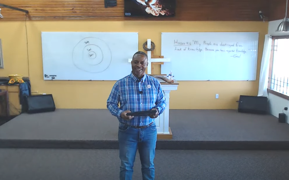an open bible is sitting on a wooden table .