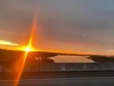 The sun is setting over a body of water.