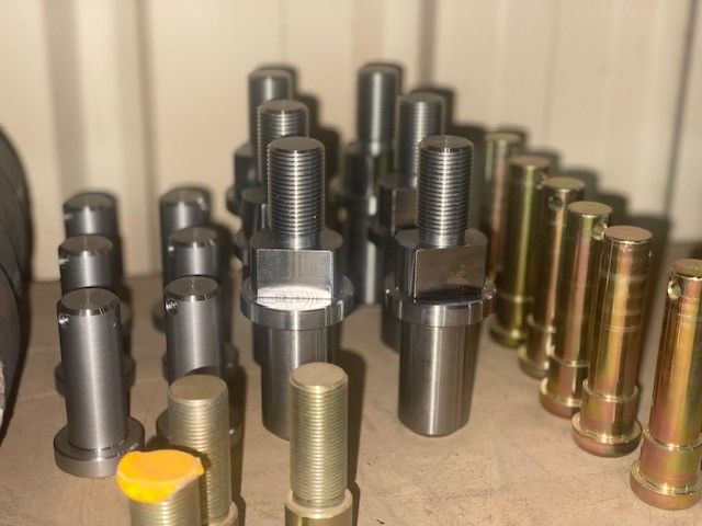 A bunch of metal pieces are sitting on a table.