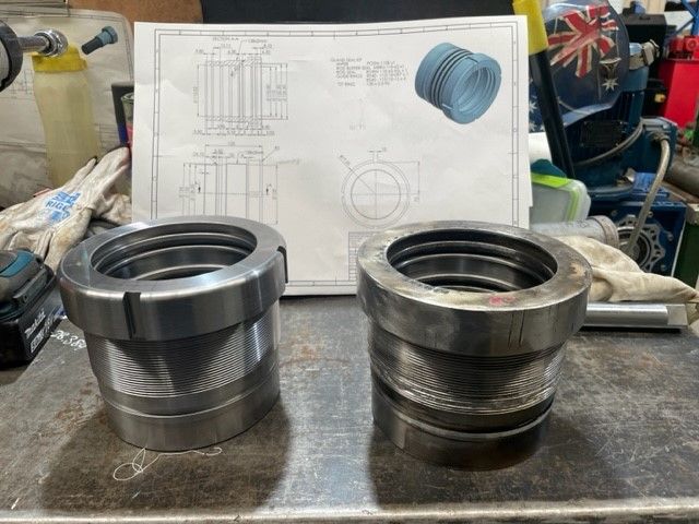 Two metal rings are sitting on a table next to a drawing.