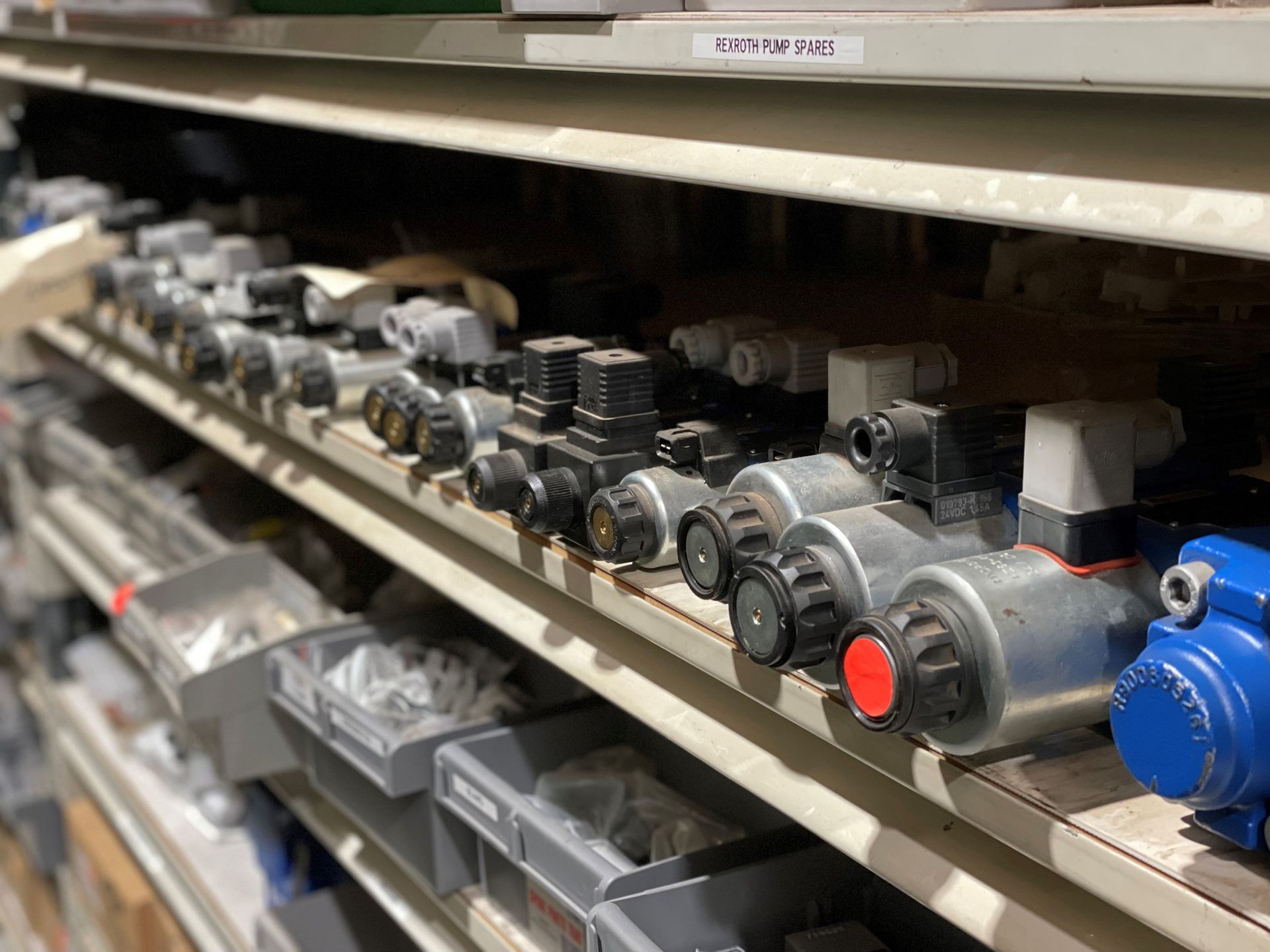 A shelf filled with lots of different types of valves.