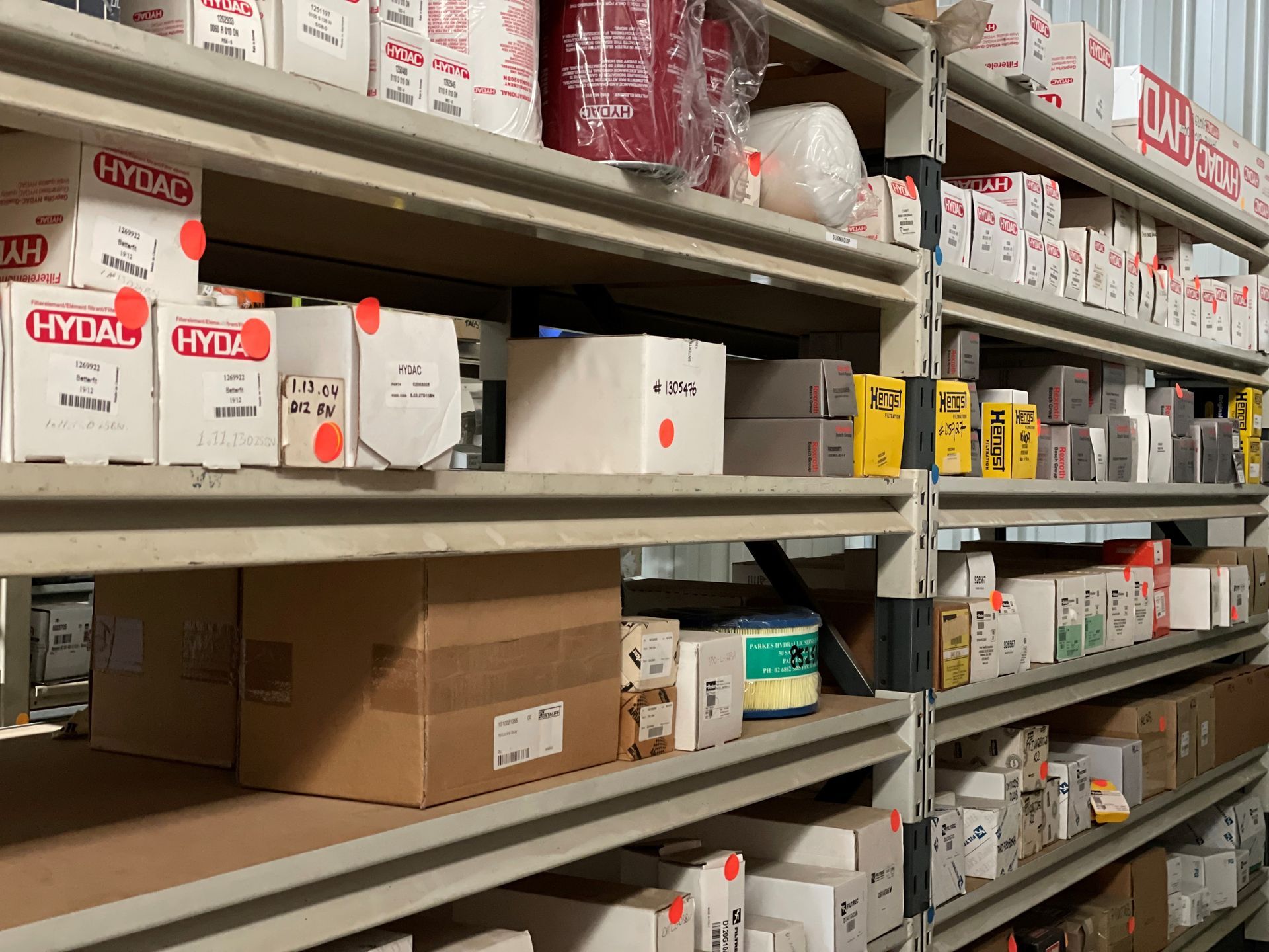 A warehouse filled with shelves filled with boxes of hydraulic parts.