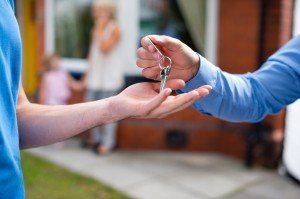 young couple clinch the deal with their estate agent