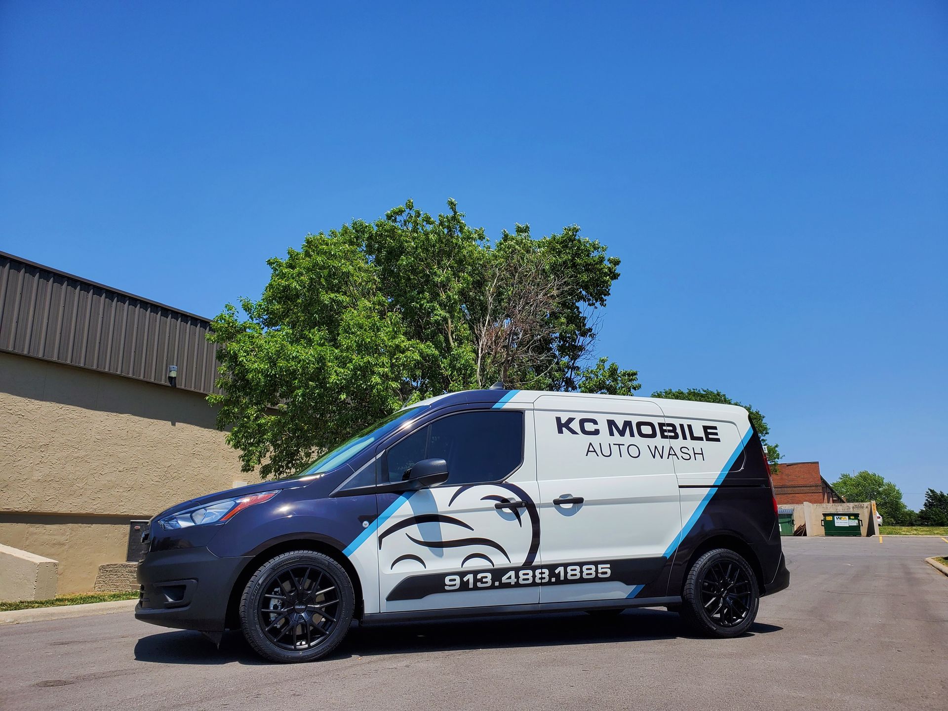 KC Mobile service van parked outdoors under a clear blue sky