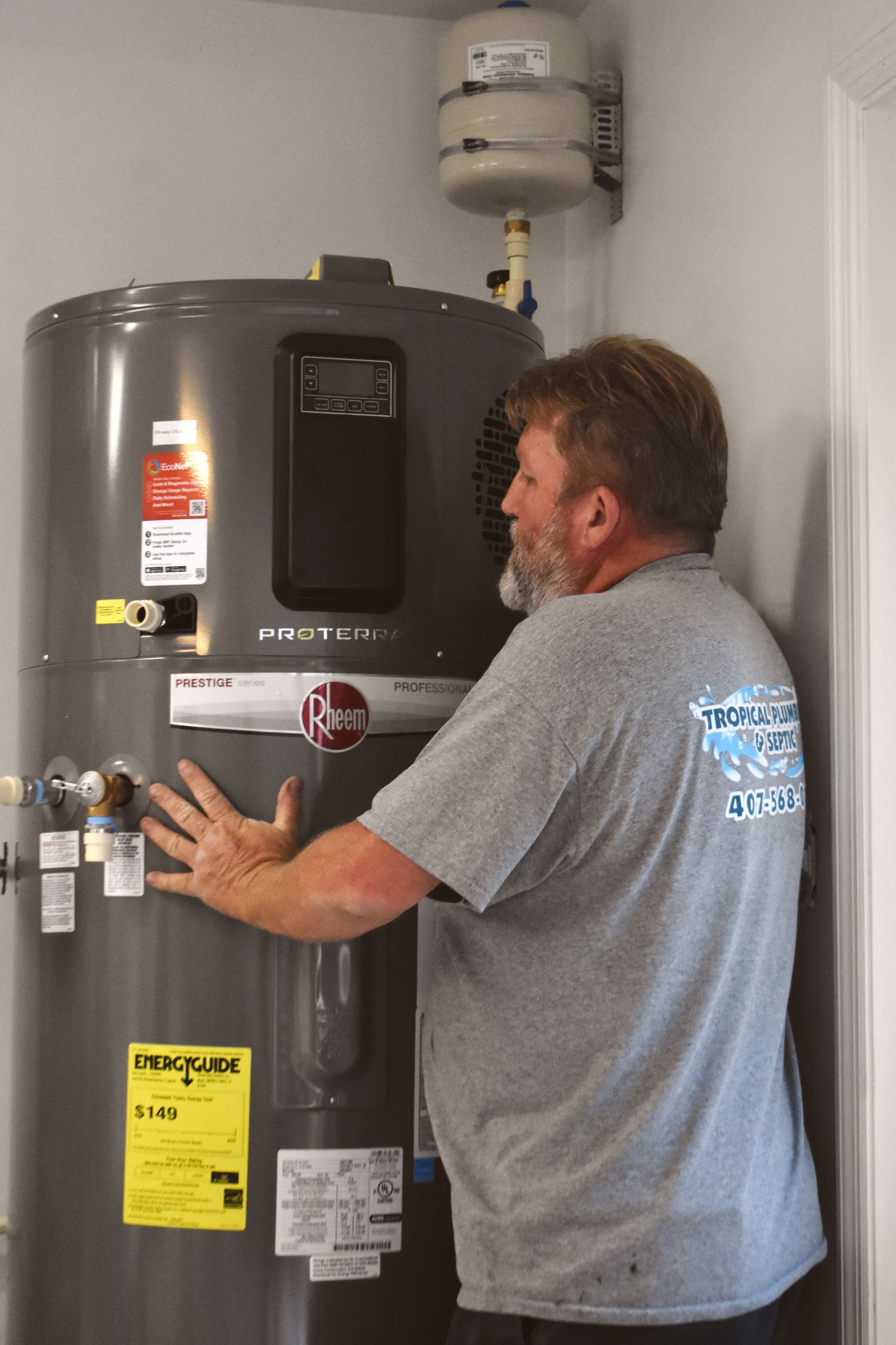 A manhole cover is sitting on the ground next to a drain.