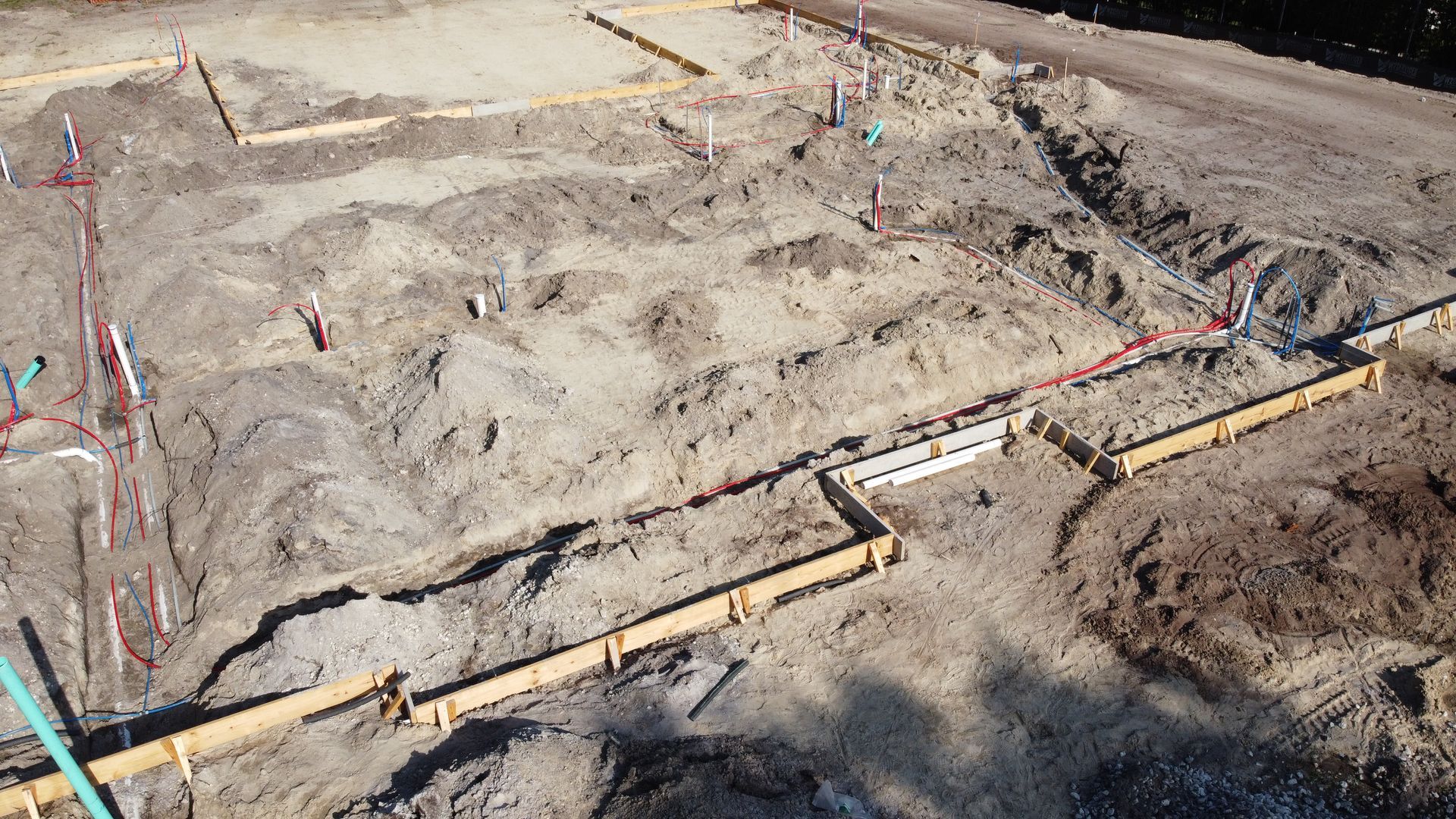 An aerial view of a construction site with a lot of dirt and concrete.