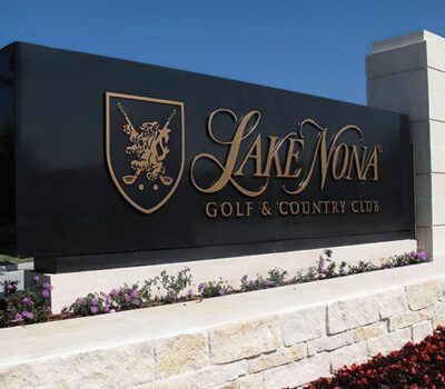 A sign for the lake nona golf and country club