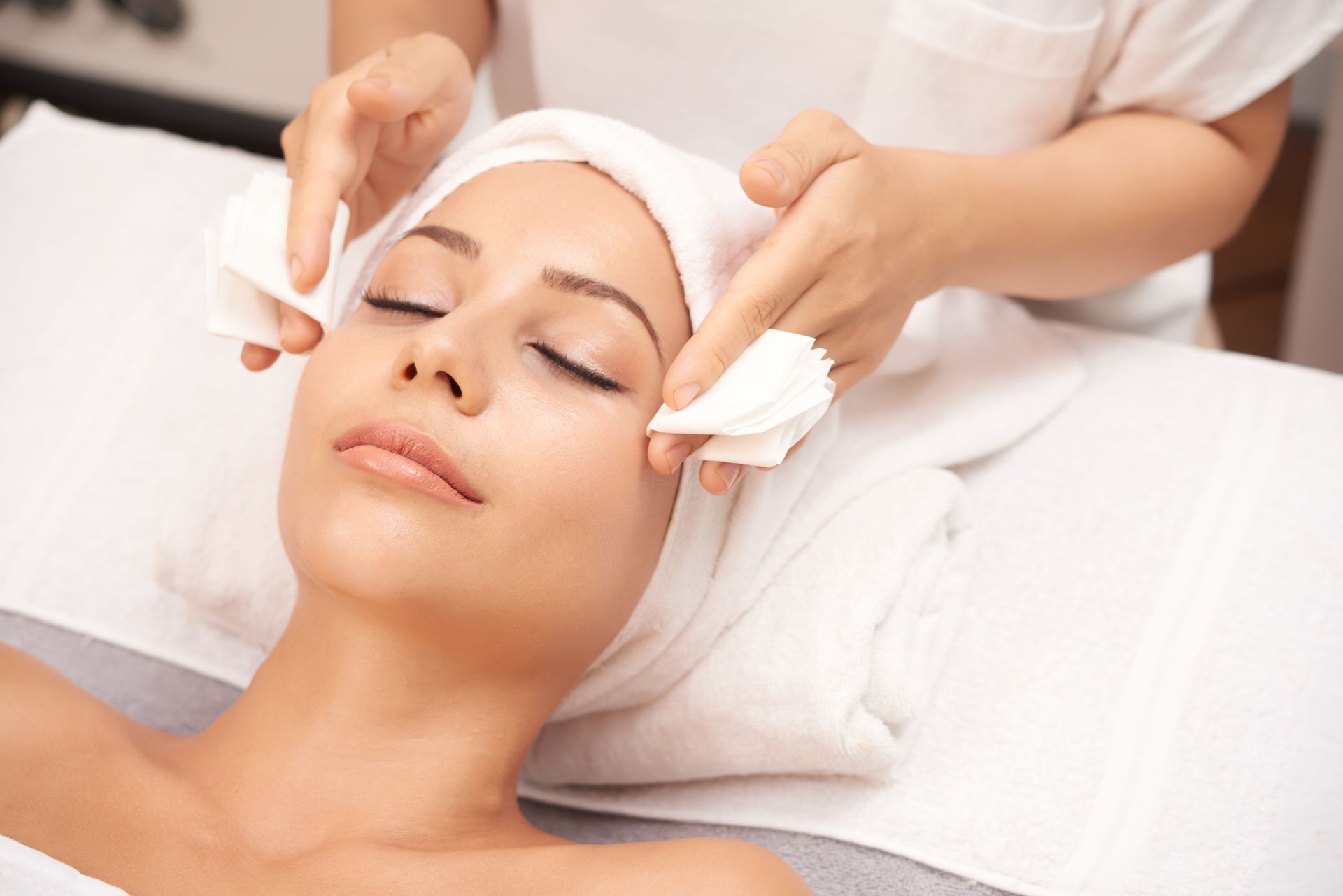 A woman is getting a facial treatment at a spa.