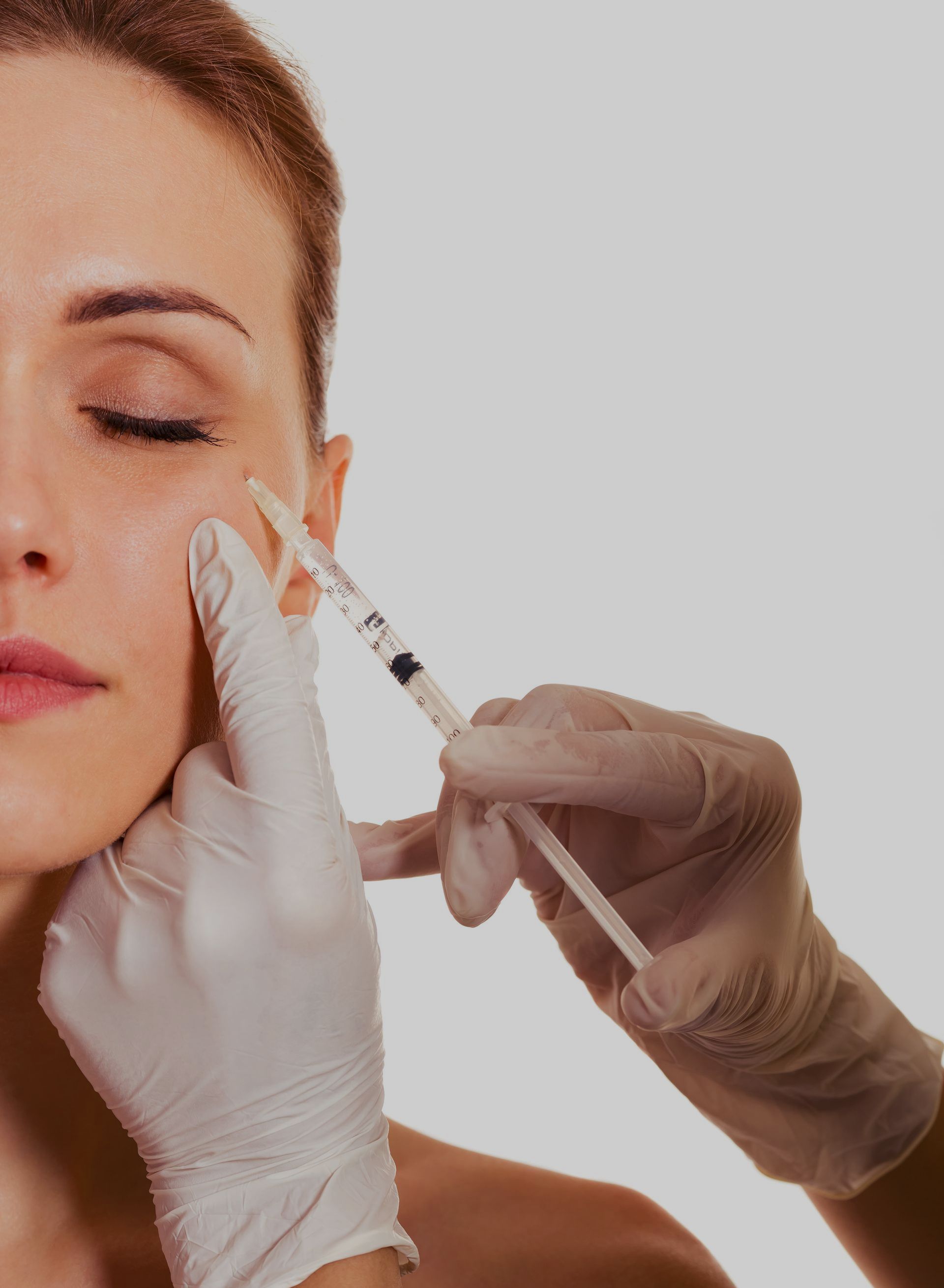 a woman is getting a botox injection in her face