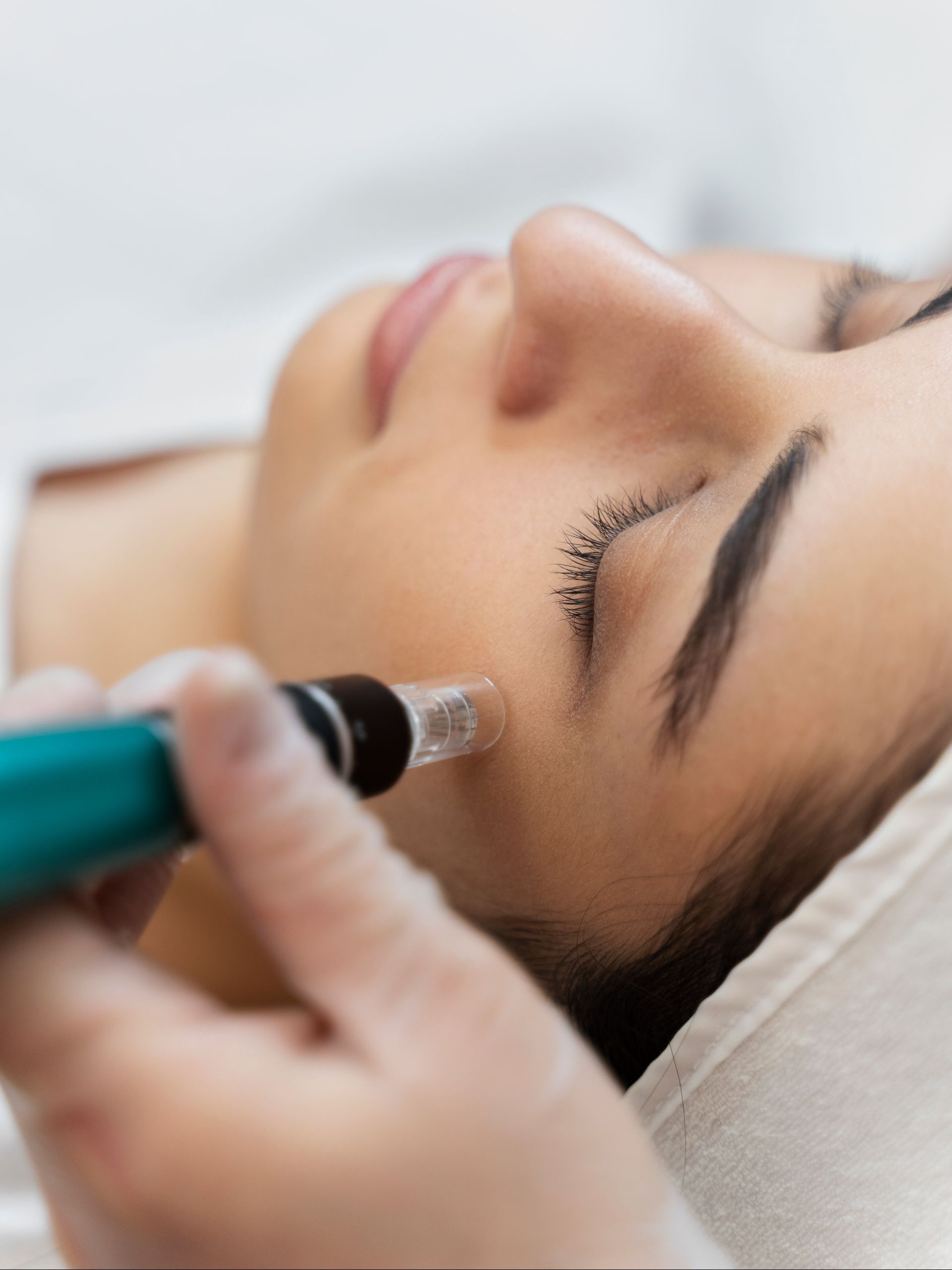 a woman is getting a treatment on her face