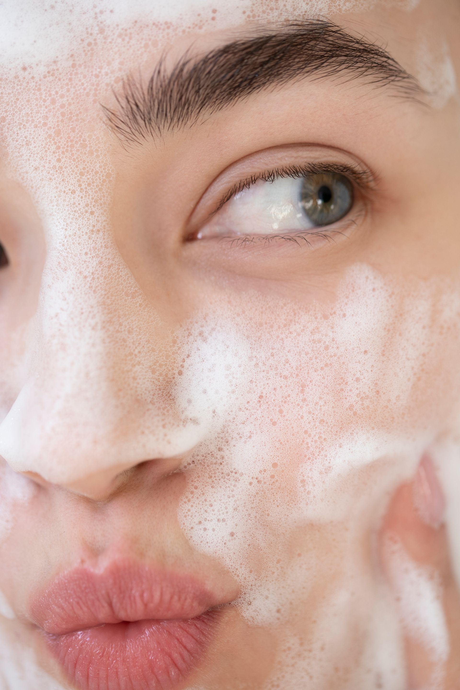 a close up of a woman 's face with foam on it