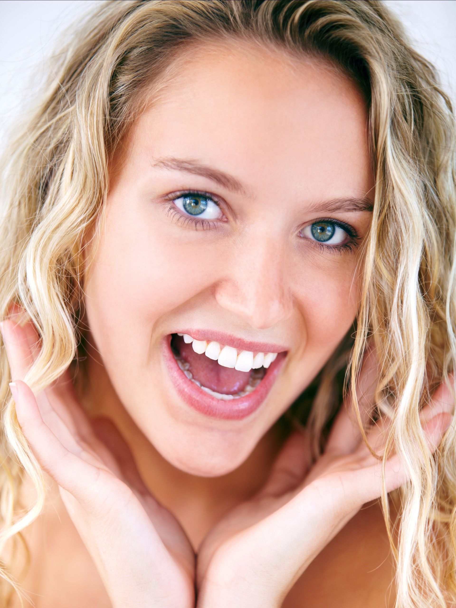 a close up of a woman 's face with her mouth open