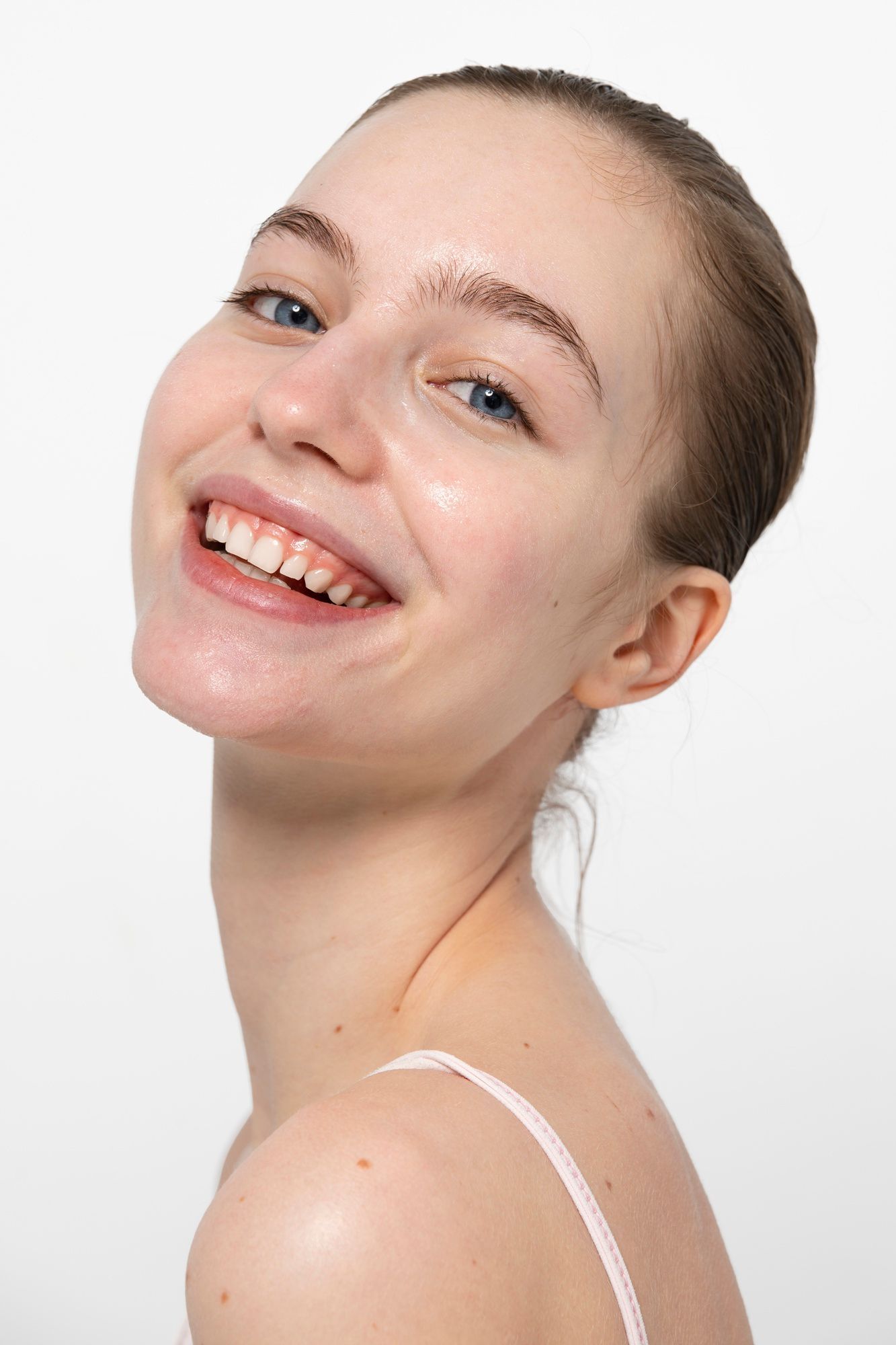 A close up of a woman 's face with a smile on her face.