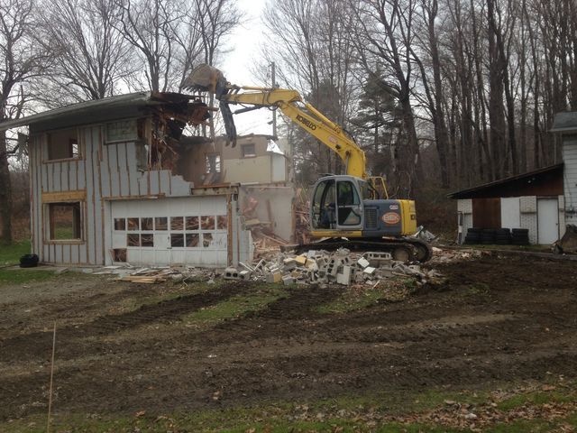 Excavator Demolishing House — Cranesville, PA — Brandon C. Kennedy Construction & Excavating