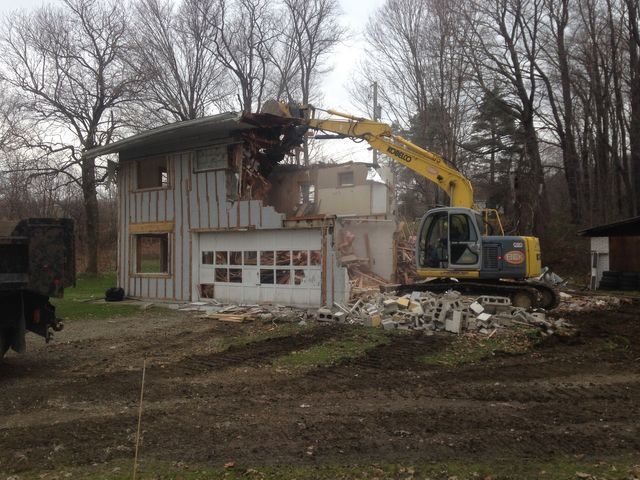 Excavator Tearing Down House — Cranesville, PA — Brandon C. Kennedy Construction & Excavating