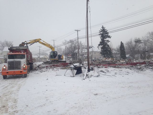 Excavator Putting Debris On Truck — Cranesville, PA — Brandon C. Kennedy Construction & Excavating