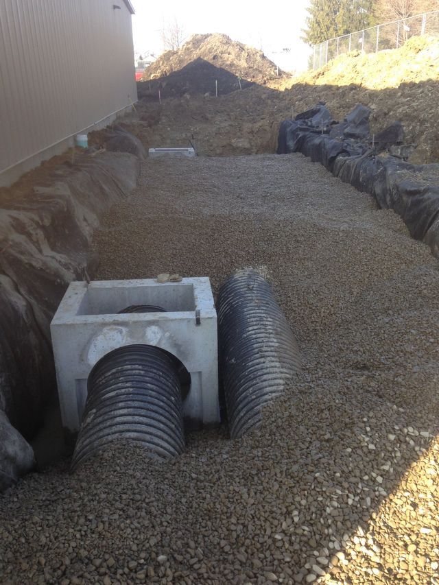 Dumping Gravel On Pipes — Cranesville, PA — Brandon C. Kennedy Construction & Excavating