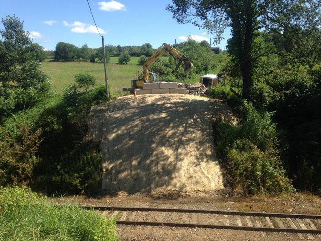 Excavator Demolishing Bridge Foundation — Cranesville, PA — Brandon C. Kennedy Construction & Excavating