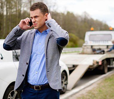 Man Calling While Tow Truck Picking Up — Towing Services in Gordonvale, QLD