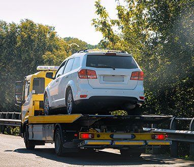 Tow Truck With a Car on the Road — Towing in Innisfail, QLD