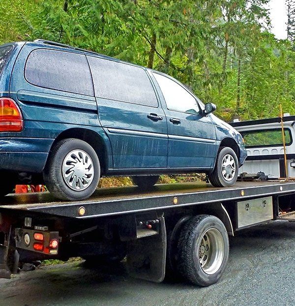 Blue Tow Truck Loaded Old Damaged Car — Accident Towing in Innisfail, QLD